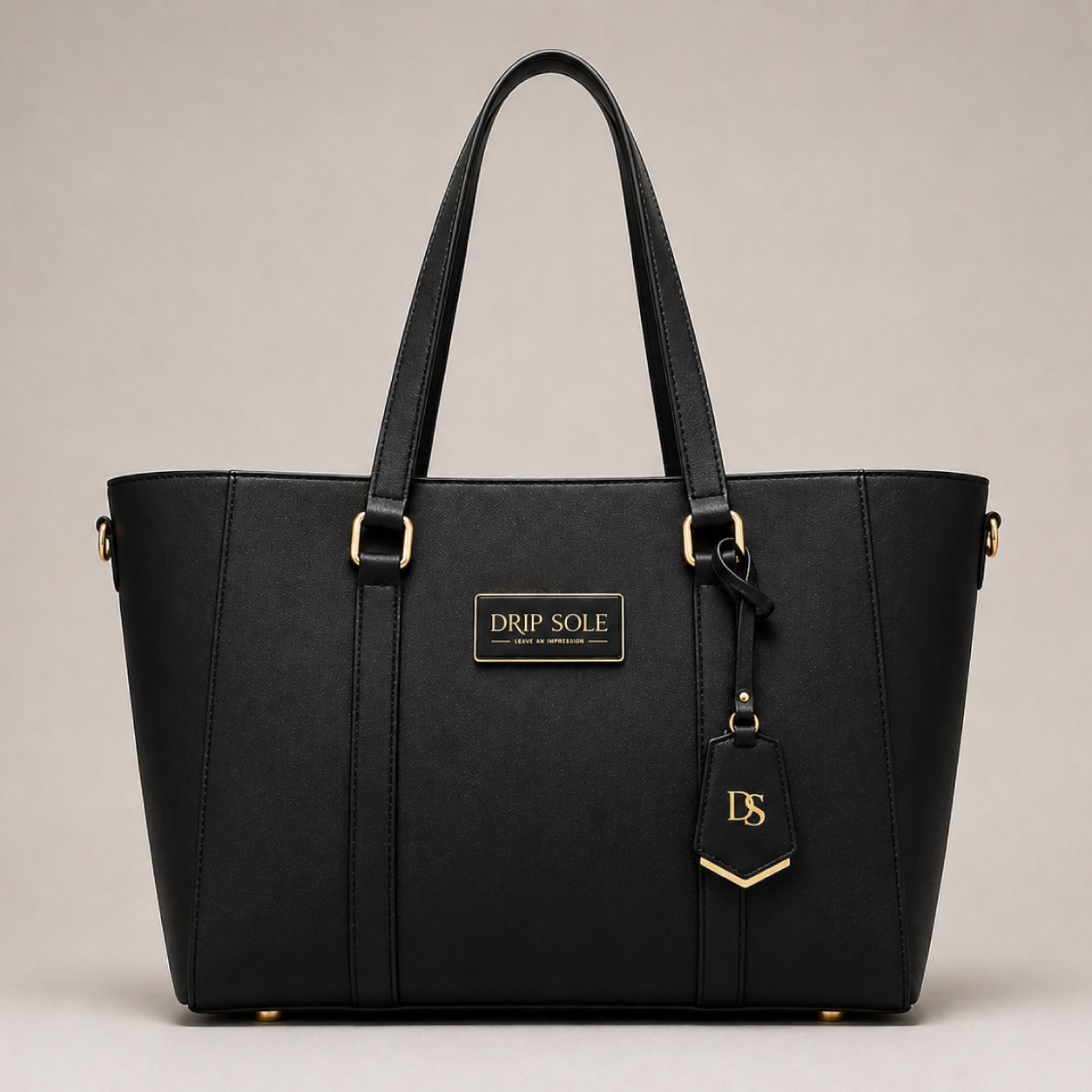 Black handbag with gold accents on a beige background