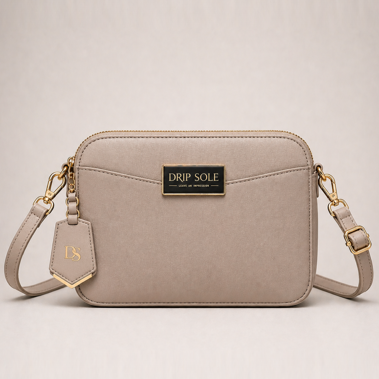 Beige handbag with gold accents on a light beige background
