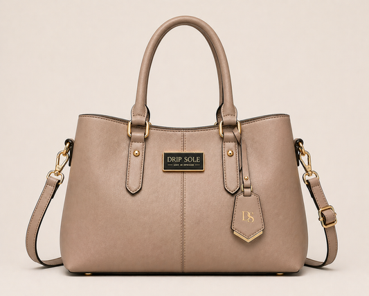 Beige handbag with gold accents on a beige background