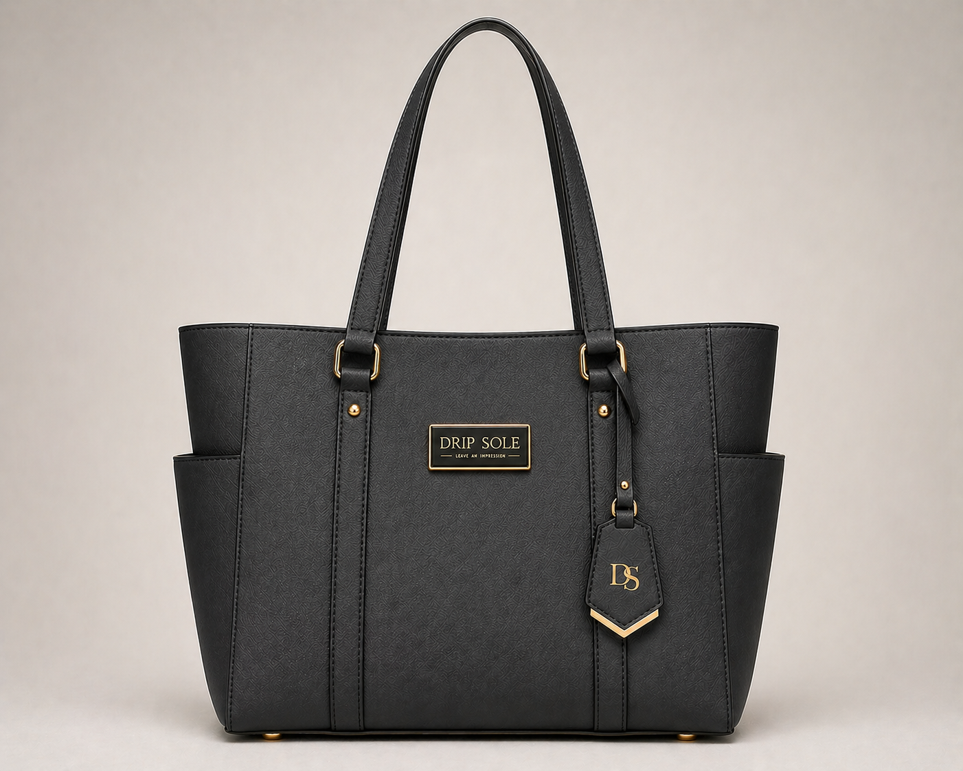 Black handbag with gold accents on a beige background