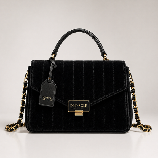 Black quilted handbag with gold chain and 'Drip Sole' tag on a light gray background